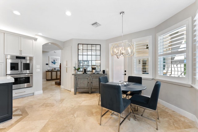 dining room featuring visible vents, baseboards, an inviting chandelier, recessed lighting, and arched walkways