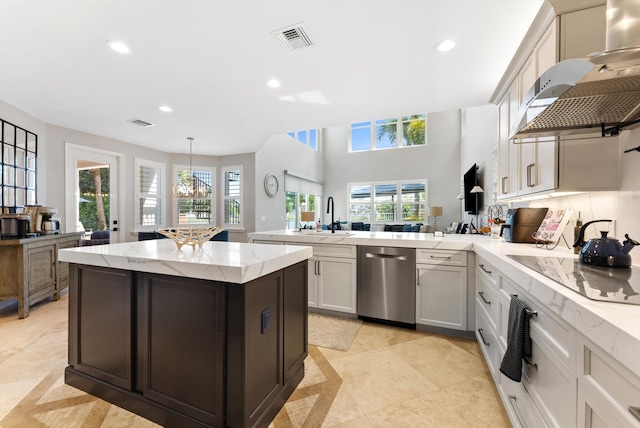 kitchen featuring visible vents, a peninsula, recessed lighting, a sink, and dishwasher