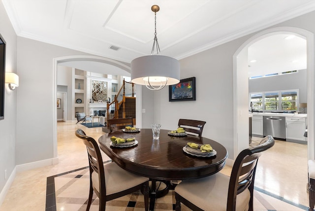 dining room featuring visible vents, built in shelves, crown molding, baseboards, and arched walkways