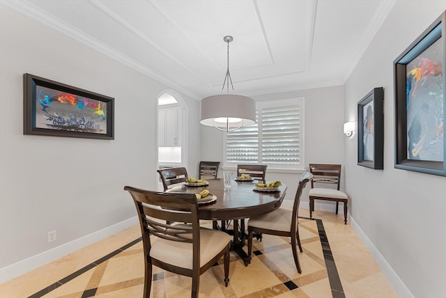 dining space with a raised ceiling, baseboards, and ornamental molding