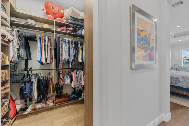 spacious closet with wood finished floors and visible vents