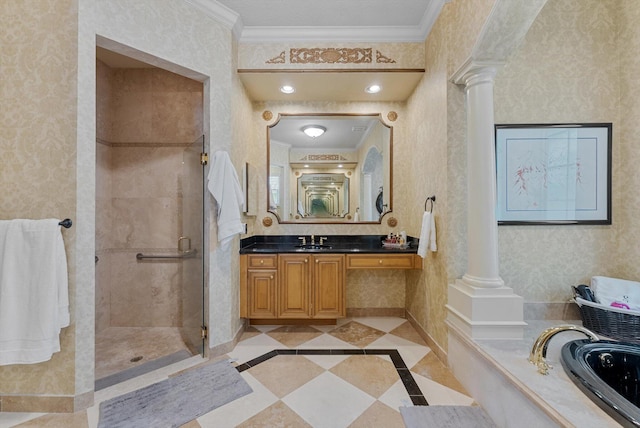 bathroom featuring wallpapered walls, a shower stall, ornate columns, and ornamental molding