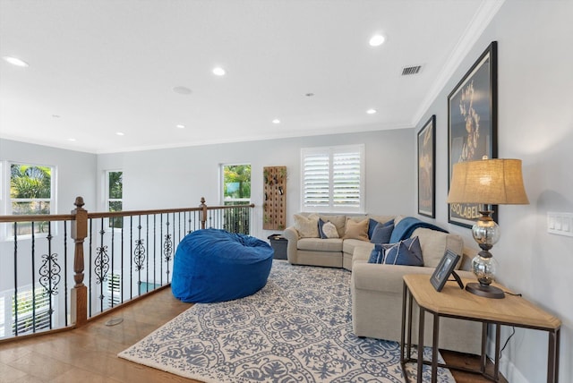 living room featuring recessed lighting, visible vents, a healthy amount of sunlight, and ornamental molding