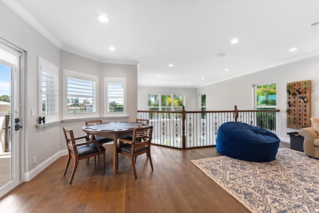 dining room with recessed lighting, baseboards, wood-type flooring, and crown molding