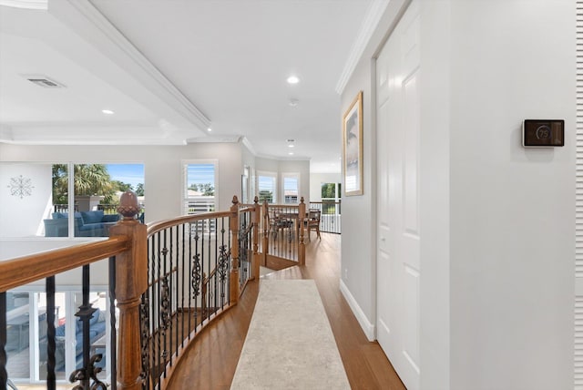 corridor with crown molding, baseboards, an upstairs landing, recessed lighting, and wood finished floors