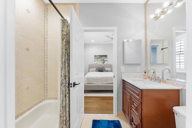 ensuite bathroom featuring tile patterned floors, shower / tub combo with curtain, toilet, ensuite bath, and vanity