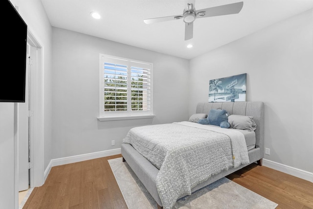 bedroom featuring recessed lighting, baseboards, wood finished floors, and ceiling fan