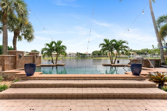 view of pool featuring a water view