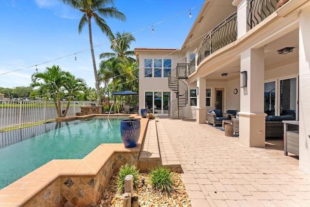 view of pool with fence, a fenced in pool, an outdoor living space, stairs, and a patio area