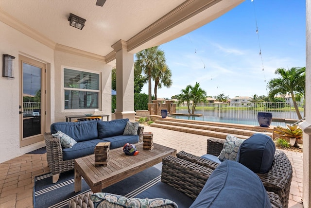 view of patio / terrace with an outdoor living space, a water view, and fence