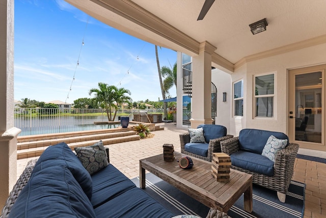 view of patio / terrace featuring outdoor lounge area, a ceiling fan, and a water view