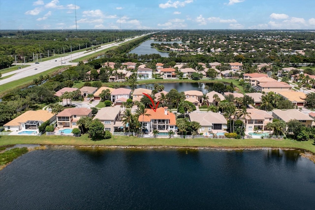 birds eye view of property with a residential view and a water view