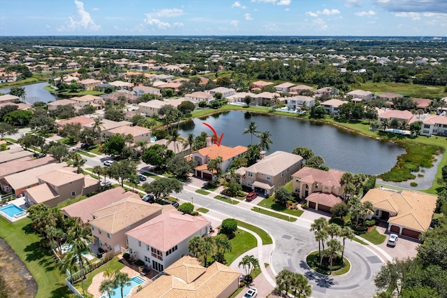 drone / aerial view featuring a residential view and a water view