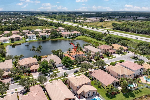 drone / aerial view with a residential view and a water view