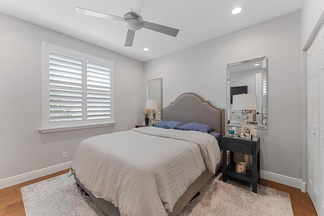 bedroom with wood finished floors, recessed lighting, a closet, baseboards, and ceiling fan