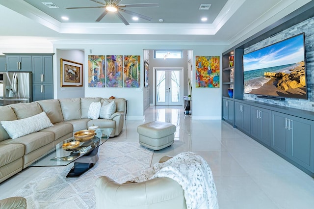 living room featuring baseboards, french doors, a raised ceiling, and visible vents