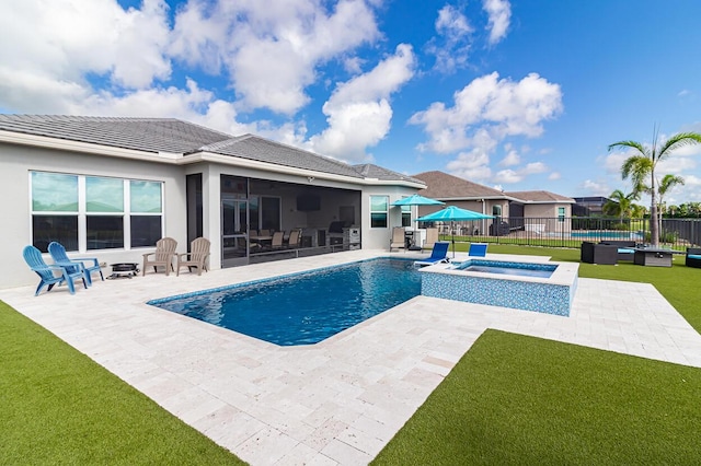 view of swimming pool featuring a lawn, an in ground hot tub, a patio, and fence