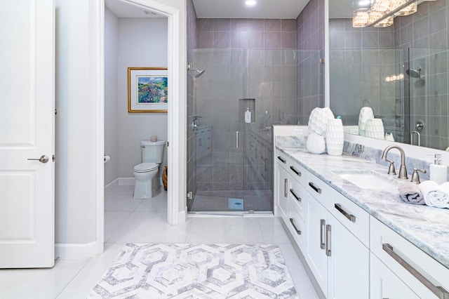 full bath with tile patterned flooring, a shower stall, and vanity