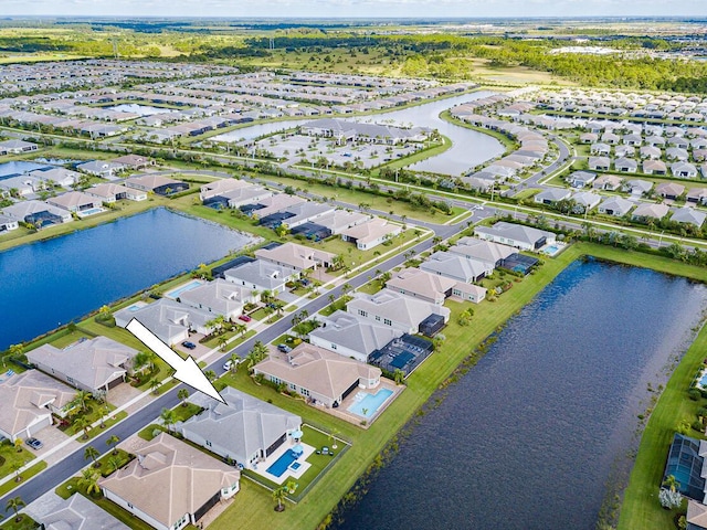 birds eye view of property featuring a residential view and a water view