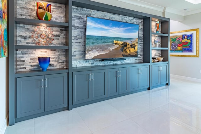 interior space with baseboards, built in shelves, and crown molding