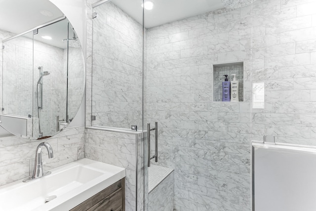 bathroom featuring vanity and a shower with shower door