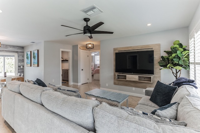 living room featuring ceiling fan and light tile patterned floors