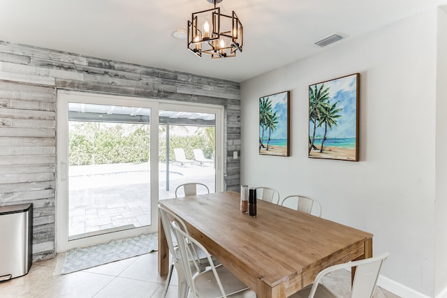 tiled dining room featuring a notable chandelier