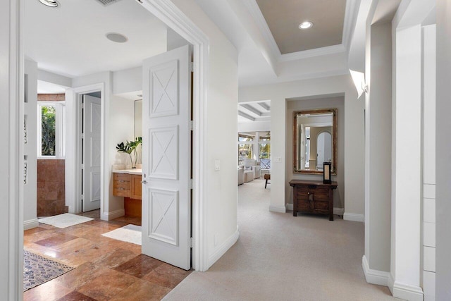 hallway featuring a healthy amount of sunlight, baseboards, light colored carpet, and recessed lighting