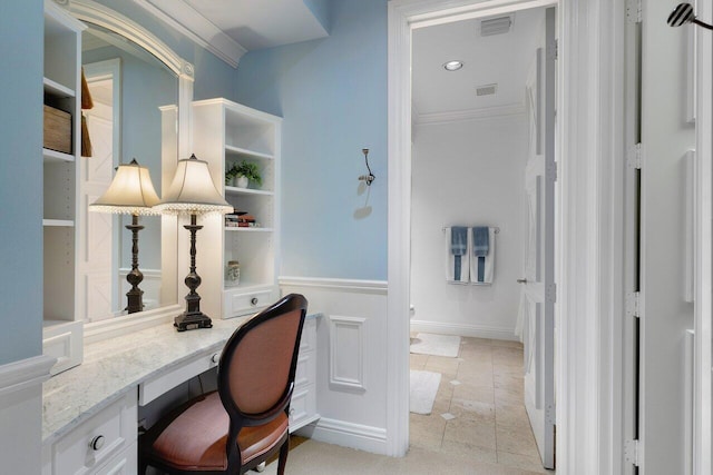 tiled office space with built in desk and ornamental molding