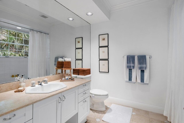 bathroom with ornamental molding, vanity, toilet, and tile patterned floors