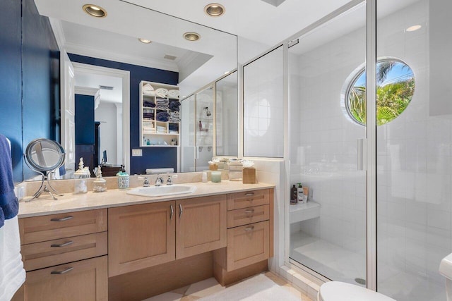 bathroom with a shower with shower door, toilet, crown molding, and vanity