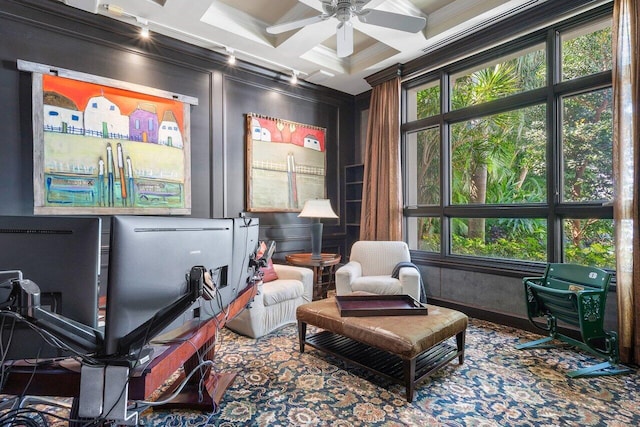 sitting room featuring beamed ceiling, coffered ceiling, carpet floors, ceiling fan, and ornamental molding