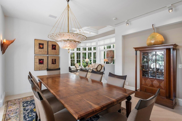 dining area featuring rail lighting and light hardwood / wood-style floors