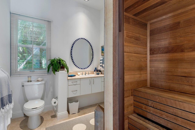 bathroom featuring tile patterned flooring, toilet, and vanity