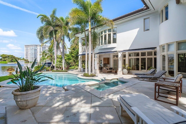 view of pool featuring a patio area and an in ground hot tub