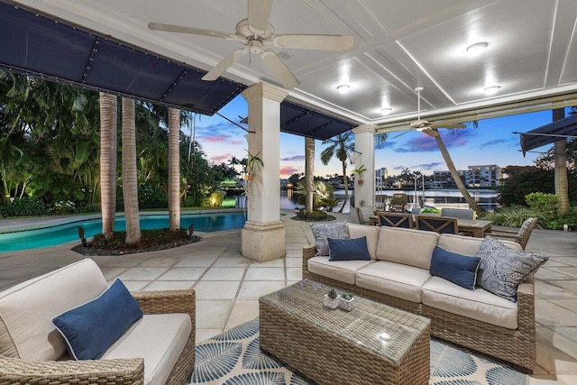 patio terrace at dusk featuring outdoor lounge area and ceiling fan