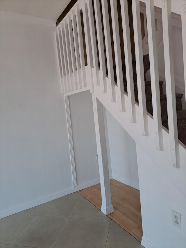 stairway with tile patterned floors