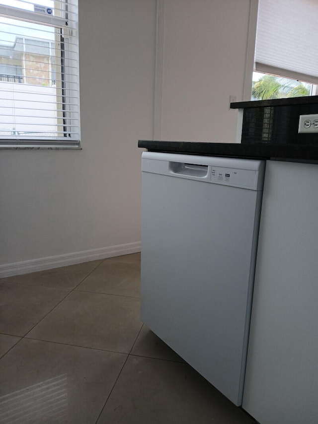 interior details featuring white dishwasher and tile patterned flooring