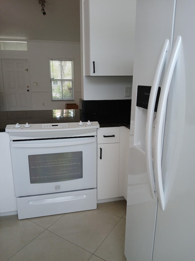 kitchen with white cabinetry, white appliances, and light tile patterned floors