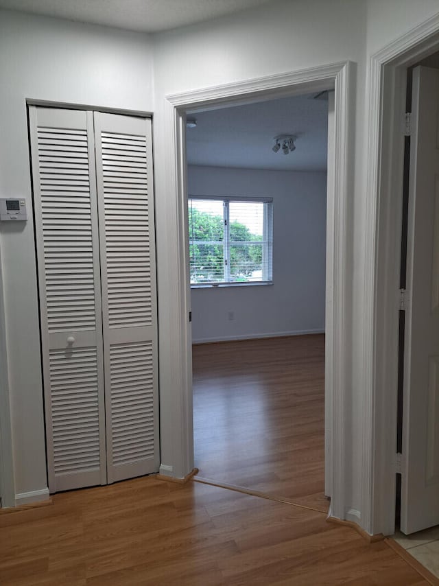 hallway with hardwood / wood-style flooring