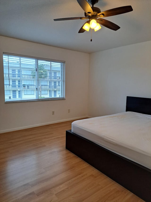 bedroom featuring hardwood / wood-style floors and ceiling fan