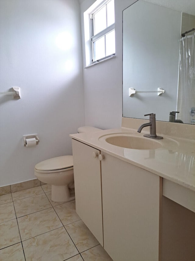 bathroom featuring tile patterned floors, toilet, curtained shower, and vanity