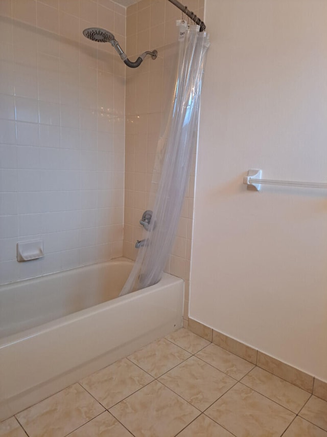 bathroom with shower / tub combo with curtain and tile patterned flooring