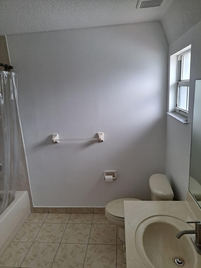 full bathroom with toilet, shower / tub combo, a textured ceiling, and tile patterned floors