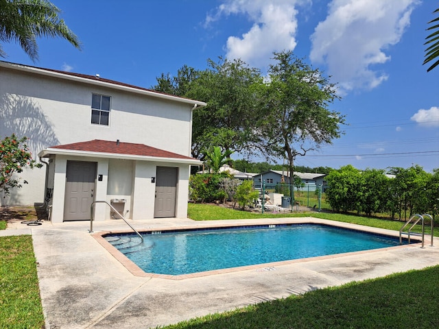 view of swimming pool featuring a lawn and a patio