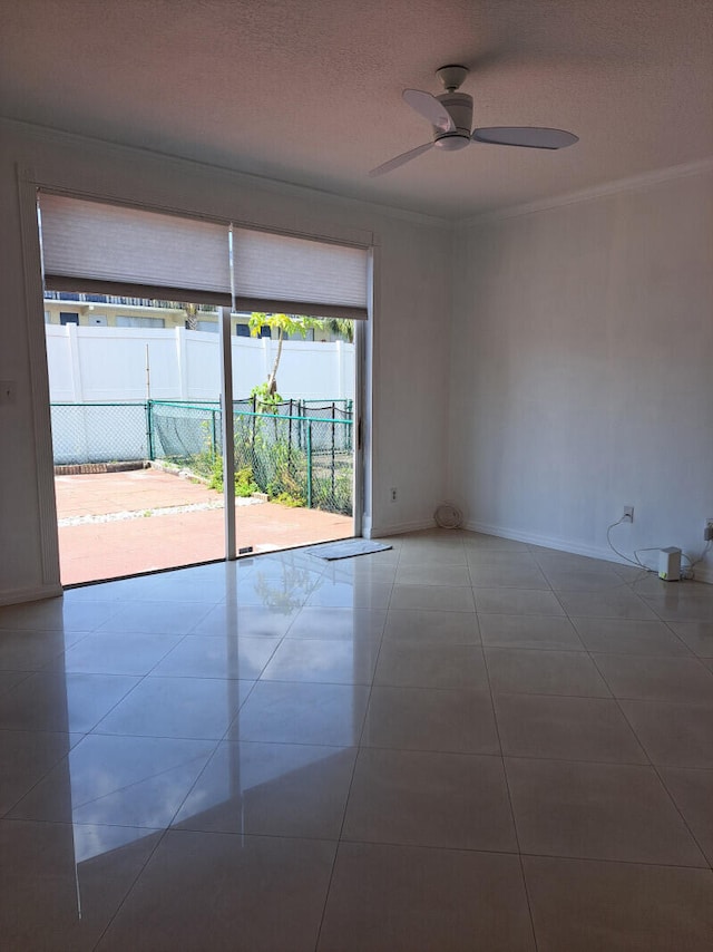 tiled spare room with ceiling fan and a textured ceiling