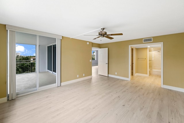 unfurnished room with light wood-type flooring and ceiling fan