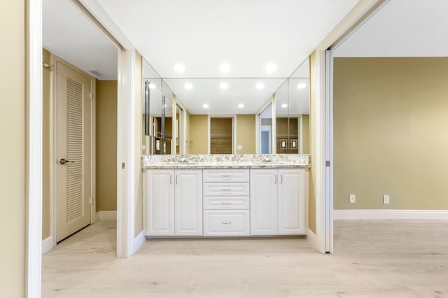 bathroom with hardwood / wood-style floors and vanity