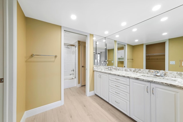 bathroom with wood-type flooring, separate shower and tub, and vanity