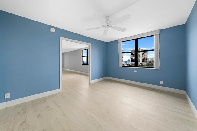 unfurnished room featuring ceiling fan and light hardwood / wood-style flooring